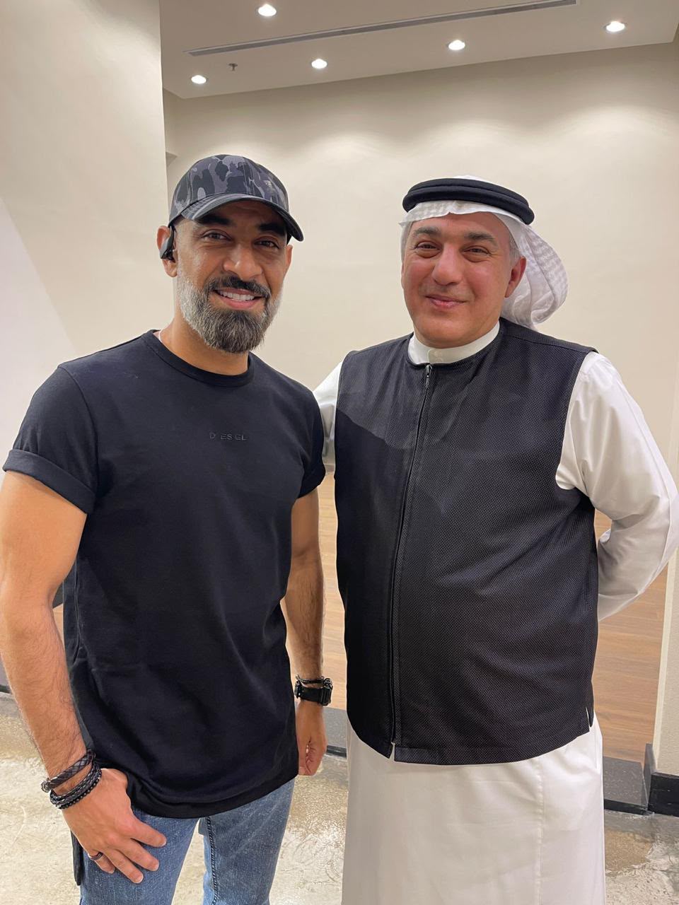 Mazin Kurdi standing with the artist Qusai Kheder.